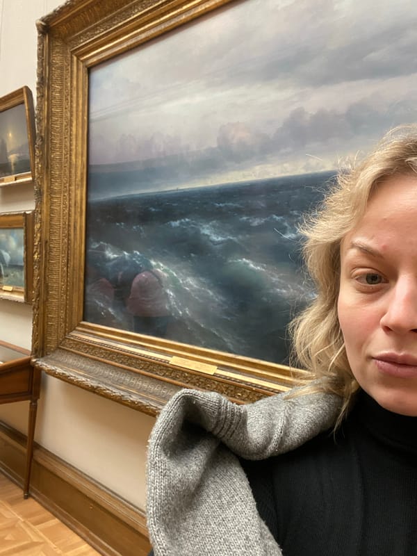 Woman poses with artwork in Moscow indoor setting