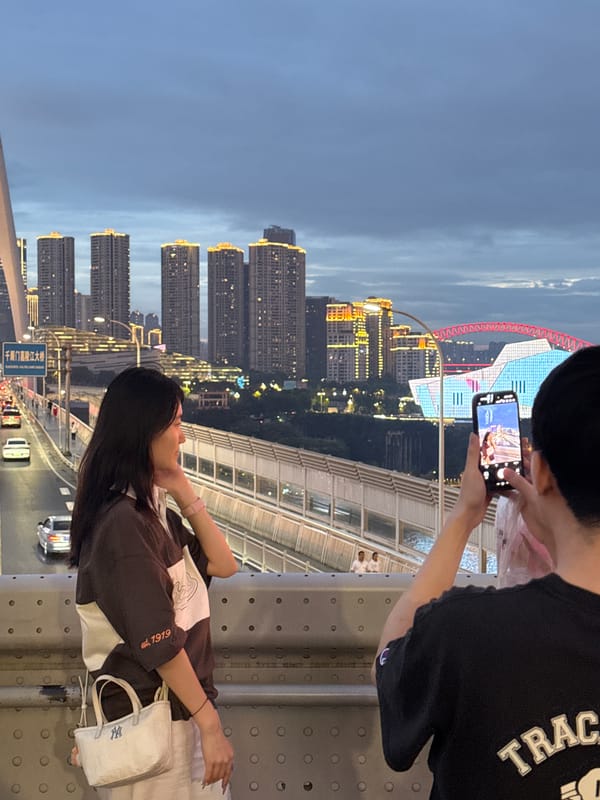 Bridge views and city lights over the Chongqing waterfront at dusk