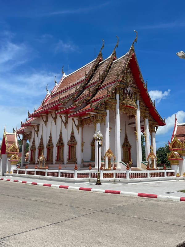 Morning visitors photograph ornate Wat Chalong temple in Thailand