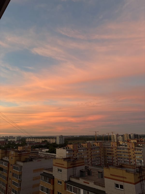 Omsk skyline glows under a pastel sunset sky