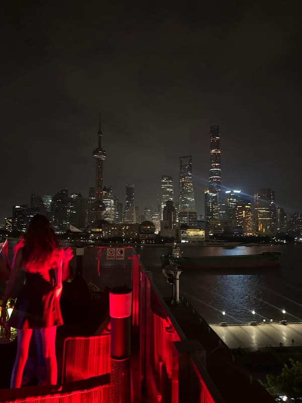 Rooftop party overlooks Shanghai skyline on summer evening