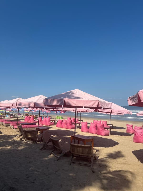 Kuta Beach scene: umbrellas, surf, and beachside bar