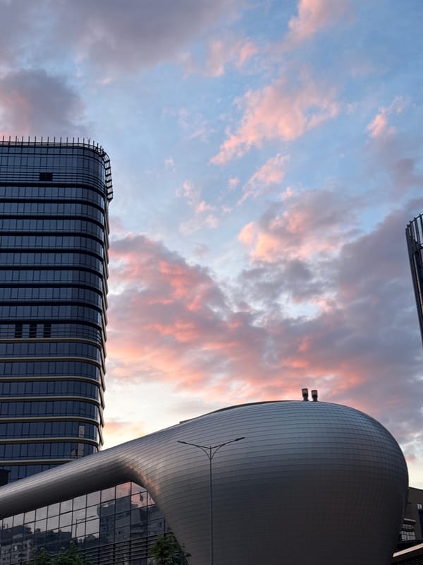 Sunset documented over modern Minsk skyline near arena complex