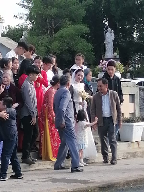 Wedding party at a Da Lat church courtyard, July 2026