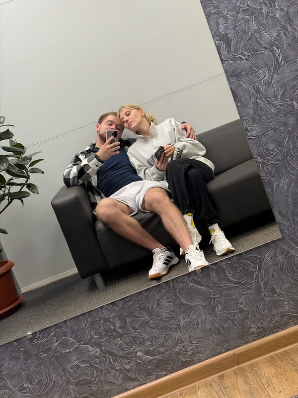 Couple relaxes on sofa in Chaikovsky residence early morning