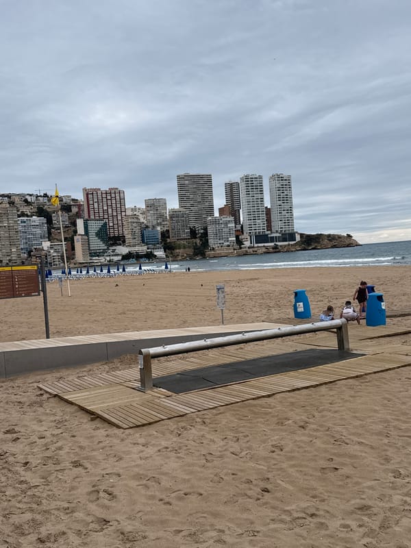 Overcast afternoon documented at Benidorm beach with organized chair setup