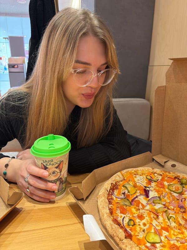 Woman dines alone at pizza restaurant in Naberezhnye Chelny