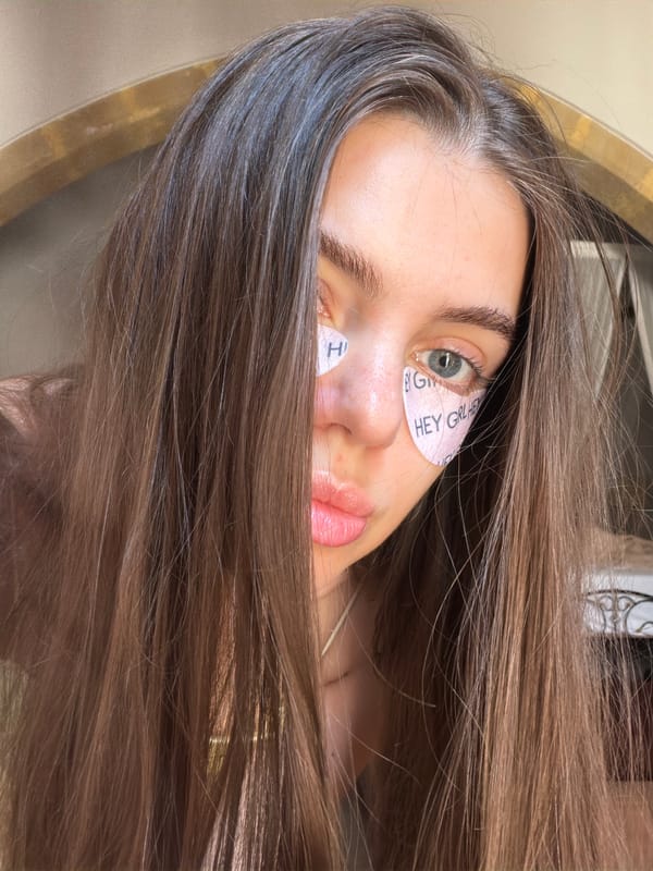 Selfie vibes and skincare patches, with a courtyard backdrop