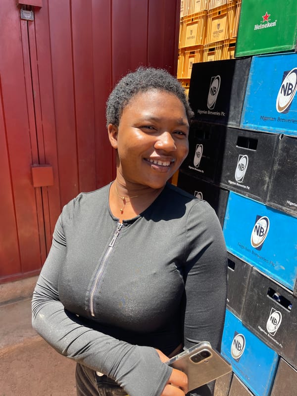 Woman poses at beverage warehouse in Gura Top, Nigeria