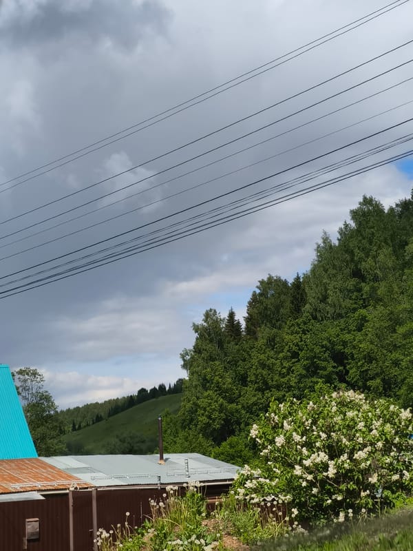 Storm clouds gather over Ольховка, Russia with blue patches
