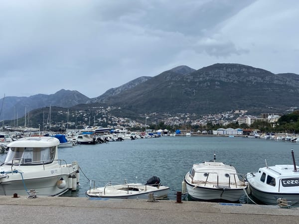 Tourists document marina and dining scenes in Bar, Montenegro