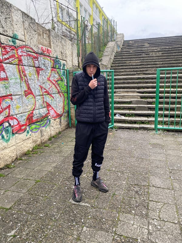 Young person photographed near graffitied stairs in Varna