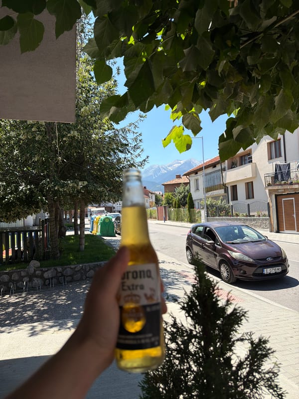 Summer afternoon in Bansko, beer in hand, mountains behind