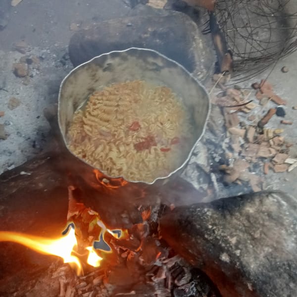 Outdoor cooking documented: pot over stone fire ring