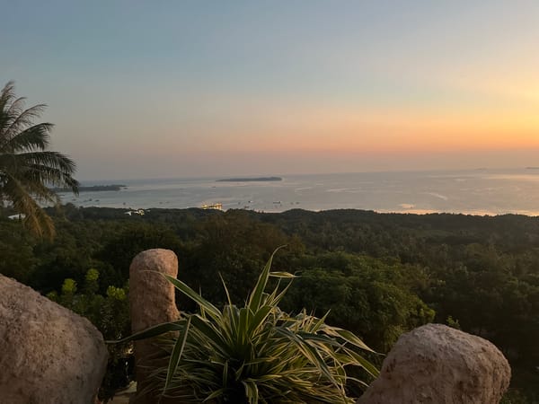 Golden hour across Karimunjawa's rocks, coastline, and hills