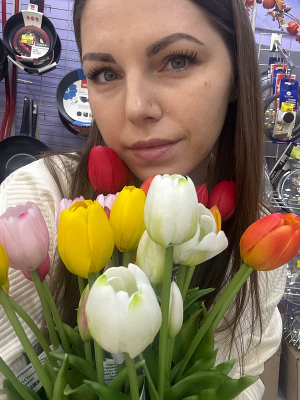 Woman takes selfies with artificial tulips in Klin store