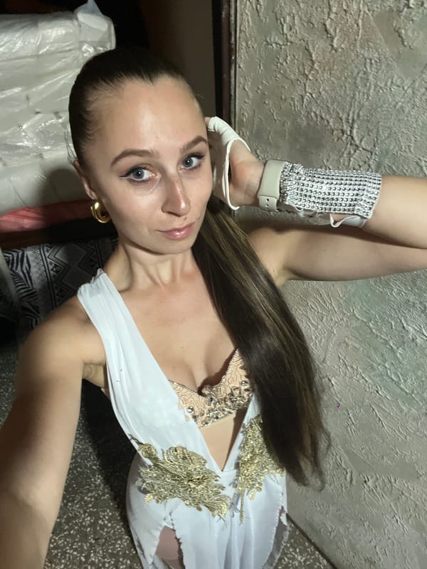 Woman poses in formal white dress in Montenegro room