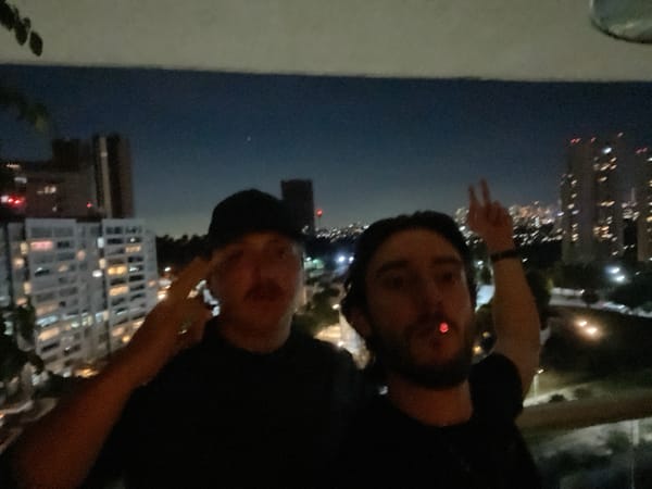 Two men photograph nighttime moment on Huixquilucan balcony