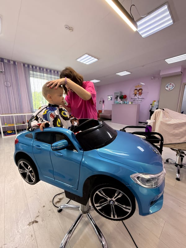 Kids' salon haircut in a blue toy car, multiple angles