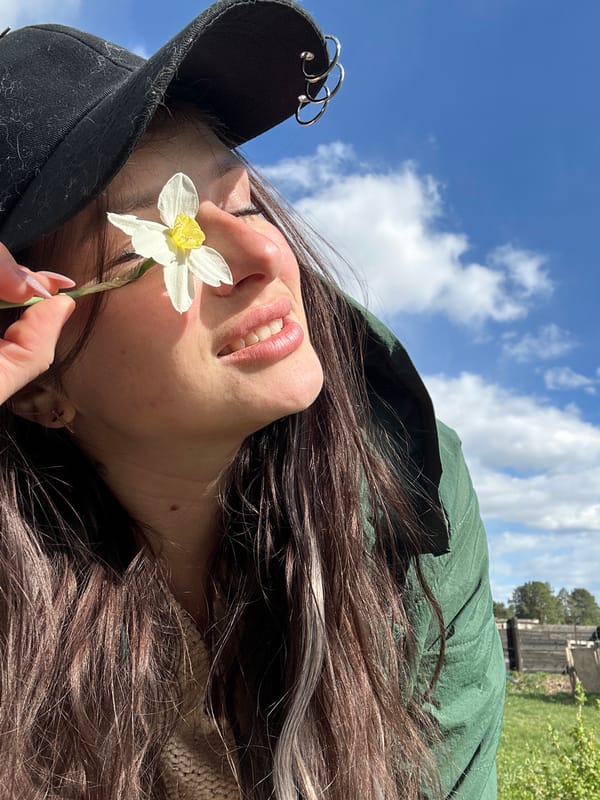 Woman photographs spring flower session in rural Russia