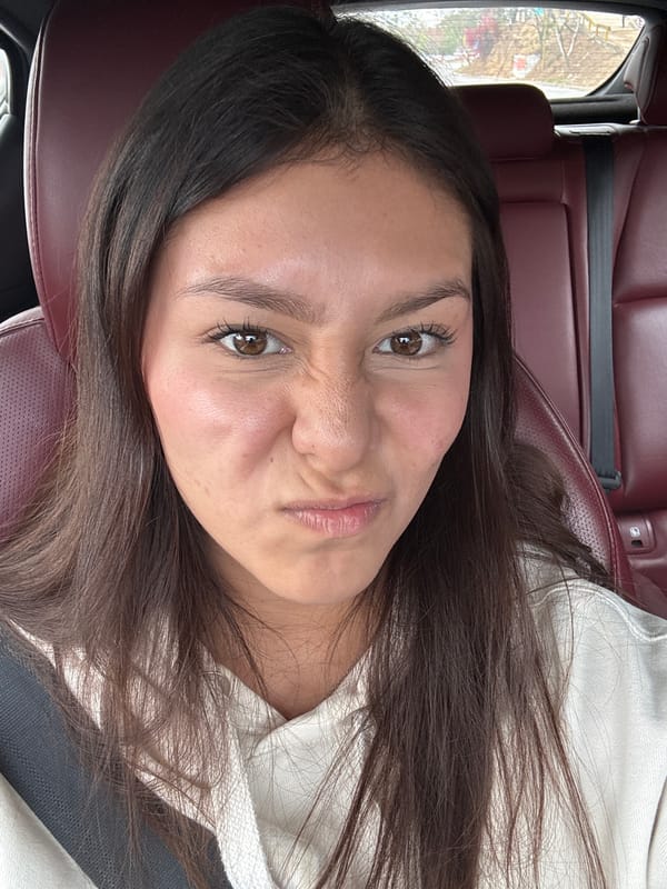 Woman poses playfully in car in Oaxaca City