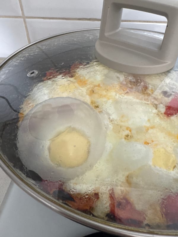 Food cooking in a covered pot on a Bat Yam stovetop