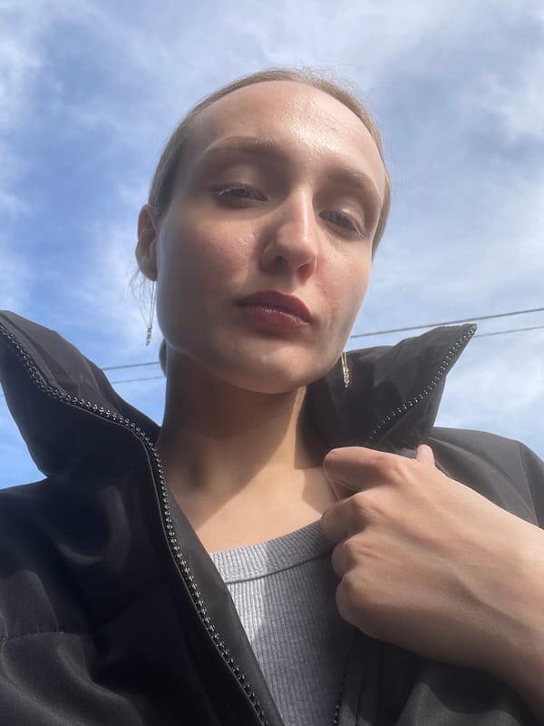 Woman takes selfie, tulips bloom in Russian village garden