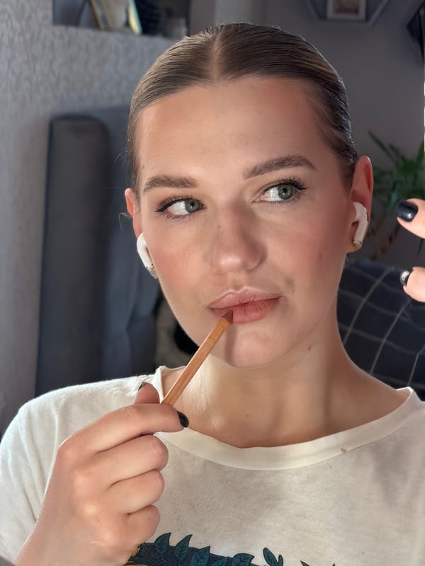Woman applies makeup in early morning hours in Latvia