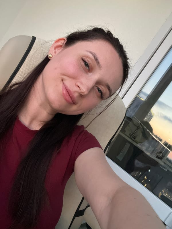 Woman takes selfies at dusk in Tyumen apartment