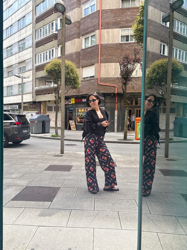 Woman with phone reflected in window, Santiago de Compostela