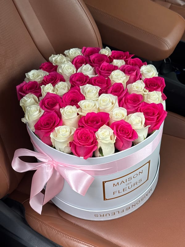 Branded rose hatbox on a car seat in Almaty