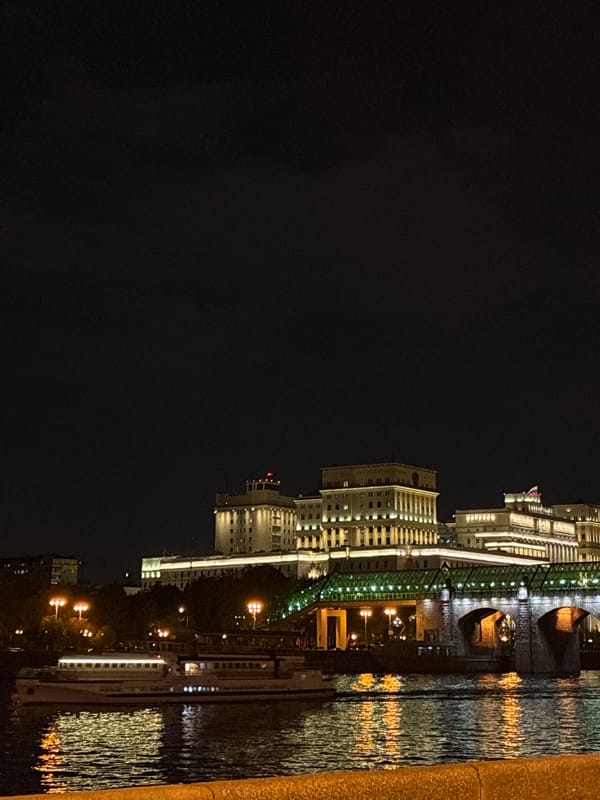 Moscow cityscape illuminated along Moskva River at night