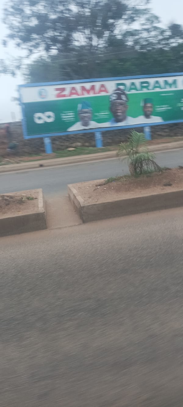 Moving vehicle captures Jos street scenes including gas station