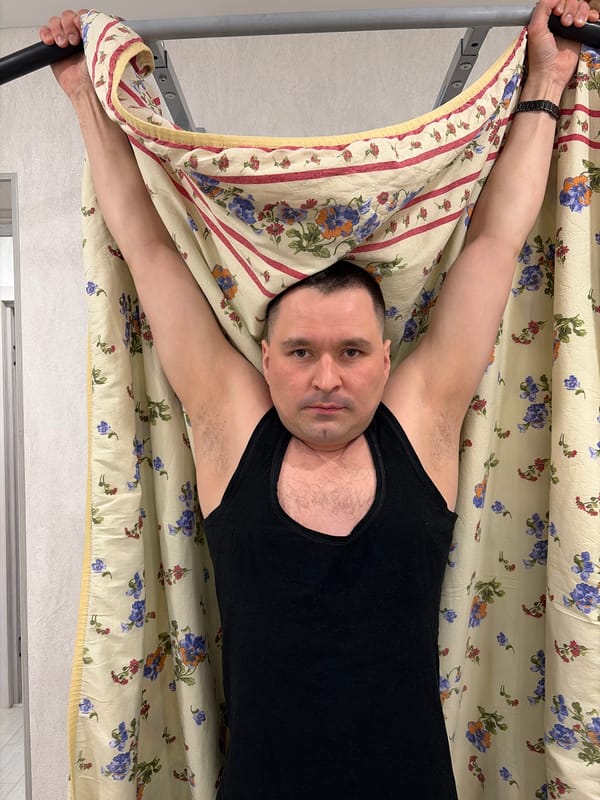 Man relaxes in bedroom with exercise equipment in Sarapul