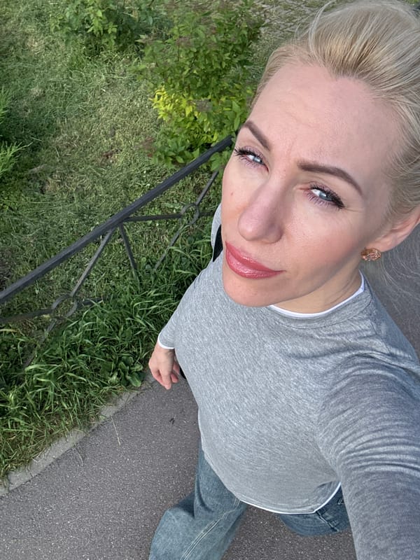 Woman takes outdoor selfies under cloudy sky