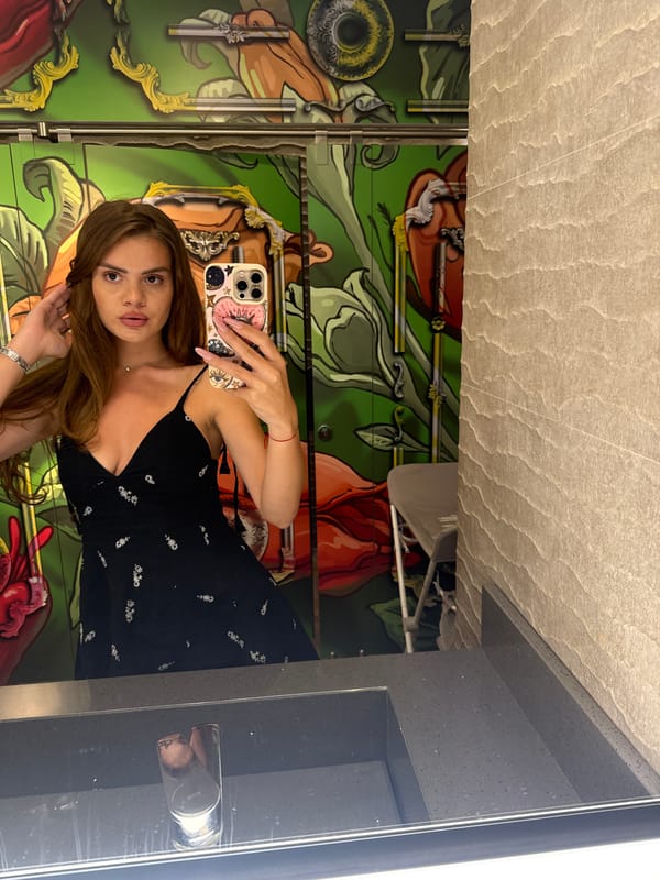 Woman documents dining experience with selfies and food photos in Plovdiv