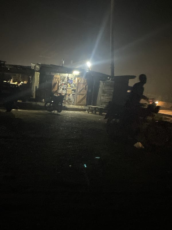 Night traffic and roadside activity along a Lokoja highway