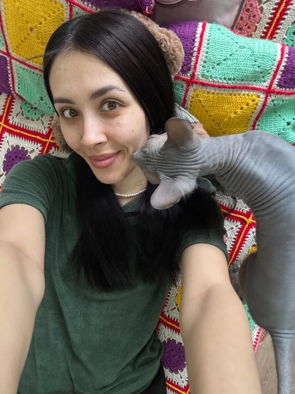 Woman with sphynx cat photographed in quiet morning moments