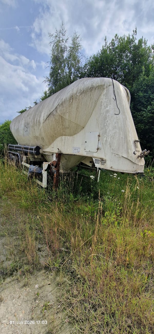 Abandoned truck wreck slowly overtaken by vegetation in rural Bavaria