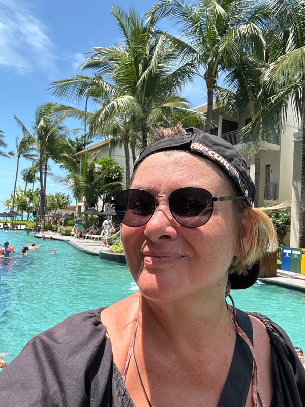Woman takes poolside selfie at Thai resort