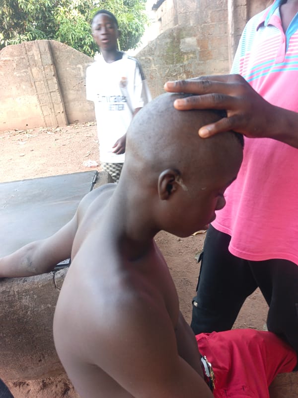 Outdoor barbering session documented in Akwanga, Nigeria