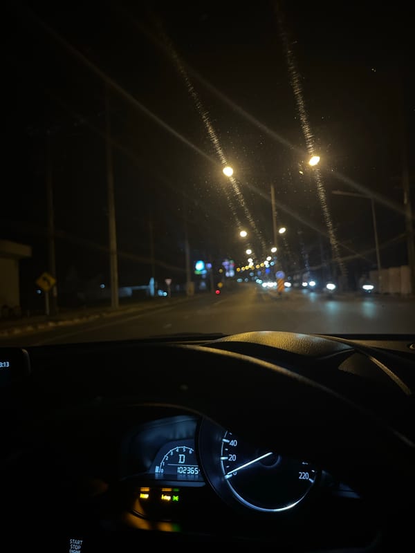 Night drive through illuminated Chalong streets captures local signage