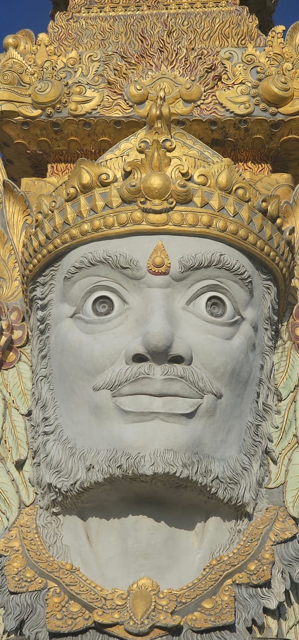Multi-faced crowned statue monument documented in Denpasar, Indonesia