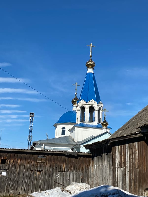 Child and woman photographed on motorcycle near Orthodox church