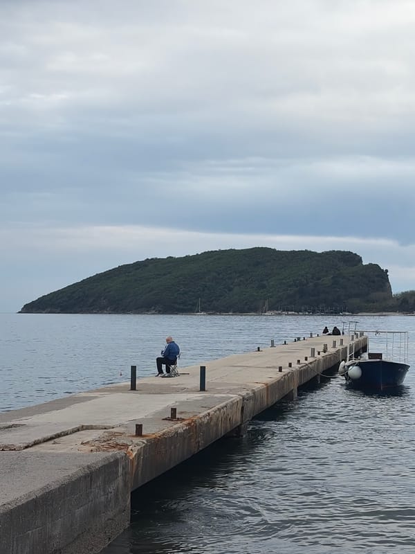Angler fishes from pier in Budva, Montenegro
