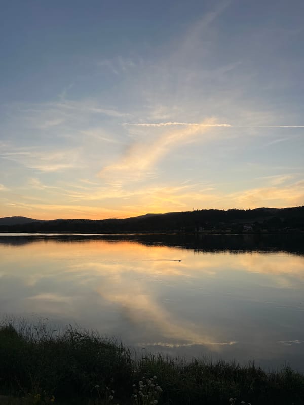 Couple enjoys evening lakeside picnic in Gondarém, Portugal