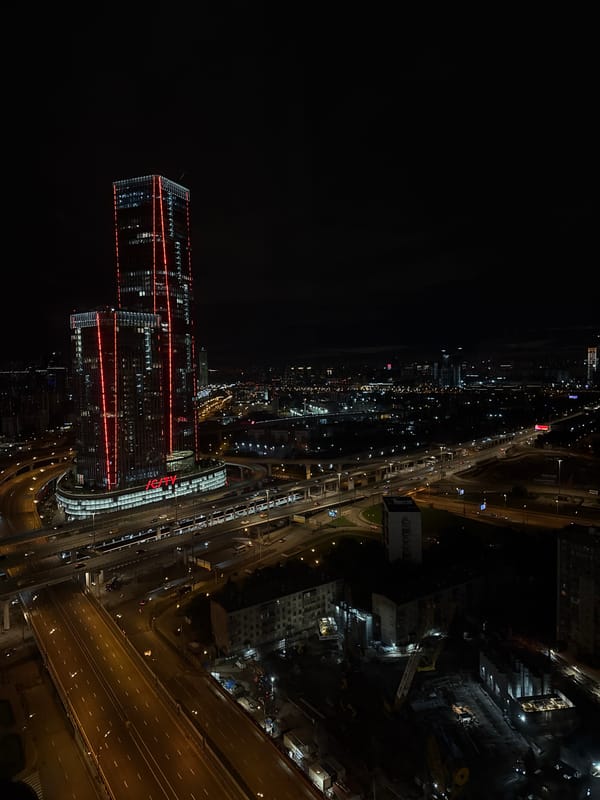 Aerial nighttime views of a city skyline anchored by ICITY towers