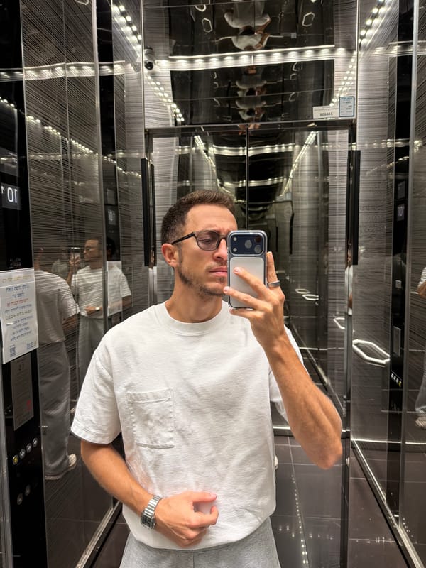 Man Takes Selfie in Mirrored Elevator