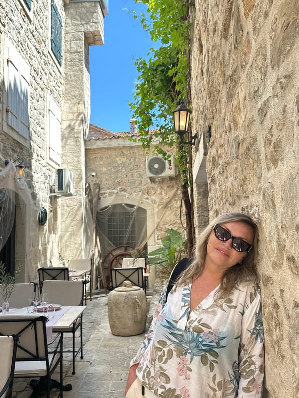 Tourist explores historic Budva streets and marina area