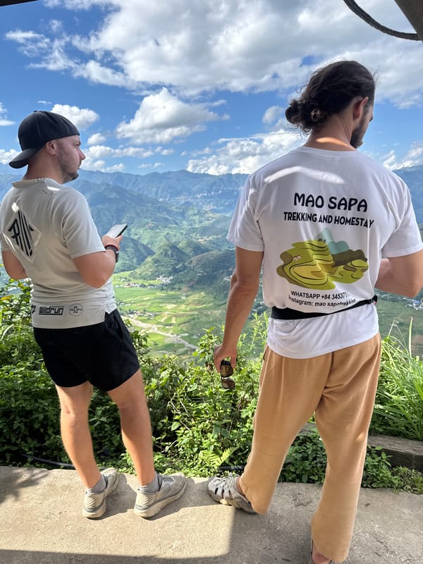 Tourists photograph scenic mountain views at Tu Le Vietnam overlooks